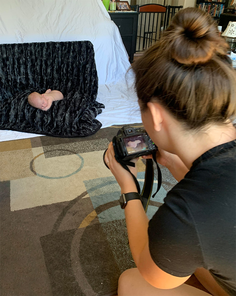 Cadie taking newborn photos at home.