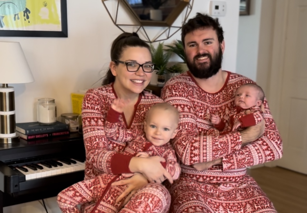 Cadie Stockman's family posing for a Christmas photo with matching red Christmas pajamas.